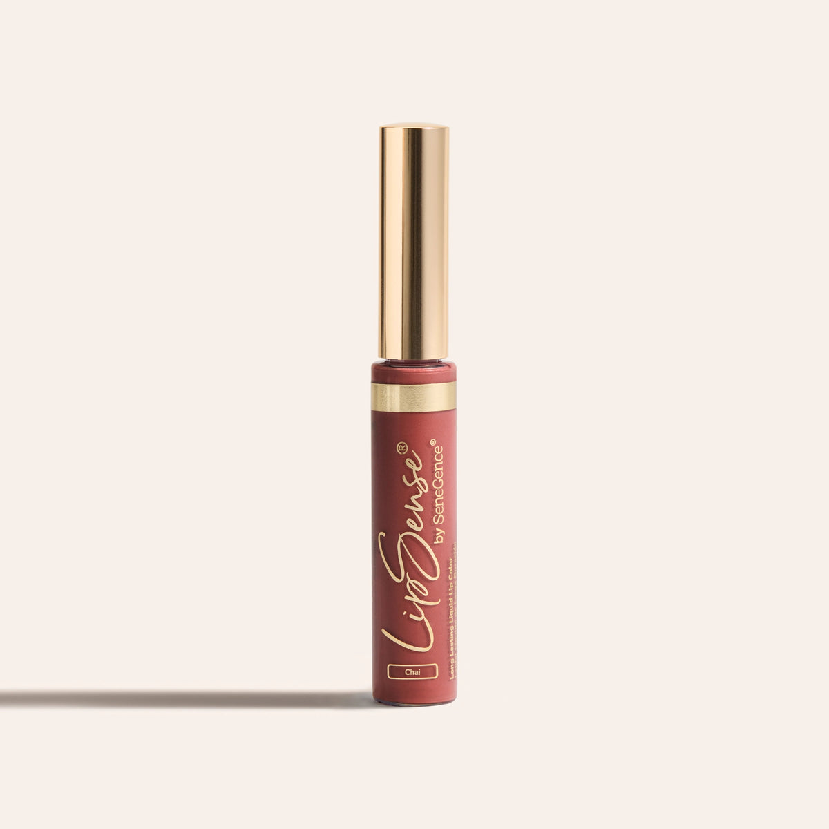 A brick-rose Chai liquid lip-color tube with a smooth gold cap and a thin gold band, LipSense® Long-Lasting Liquid Lip Color.