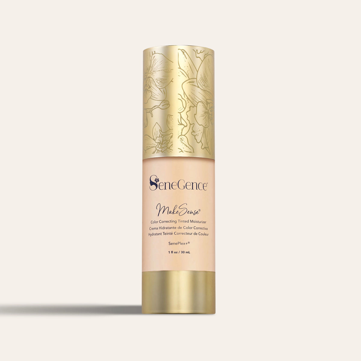 A beige bottle with a gold orchid-engraved cap and gold base, MakeSense® Color Correcting Tinted Moisturizer.