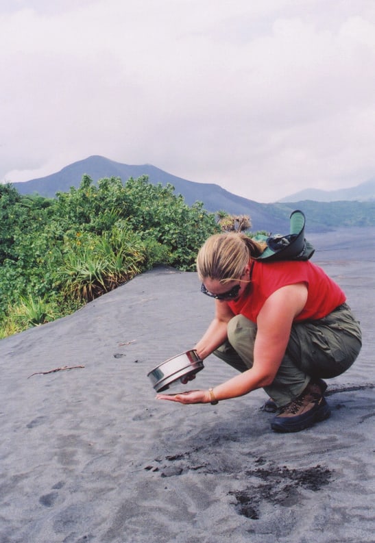 Joni Rogers-Kante, founder of SeneGence, sifting volcanic ash at Mount Yasur in Vanuatu