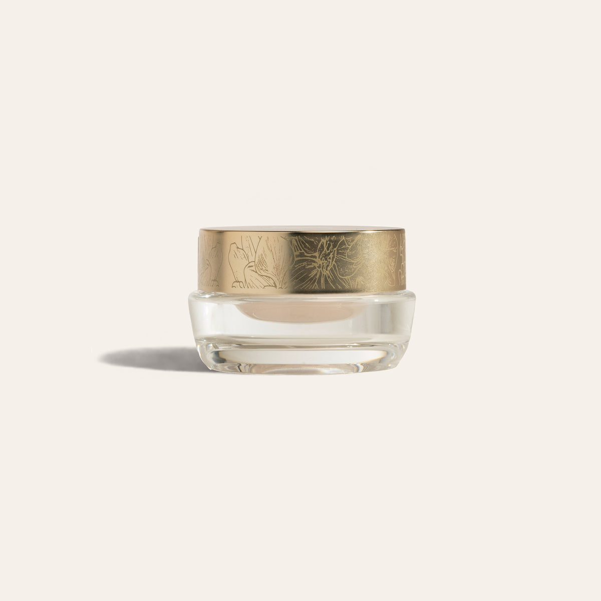 EyeCrème by SeneGence: A clear jar of pale cream with an orchid-engraved gold lid.
