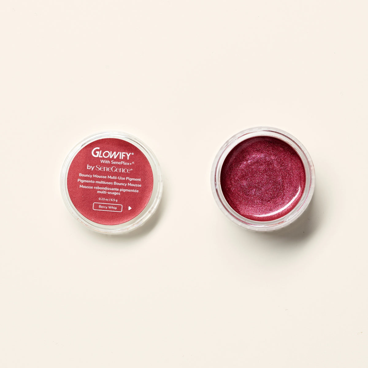 Glowify Bouncy Mousse Multi-Use Pigment by SeneGence: An open pot of shimmering berry pigment beside its labeled lid.