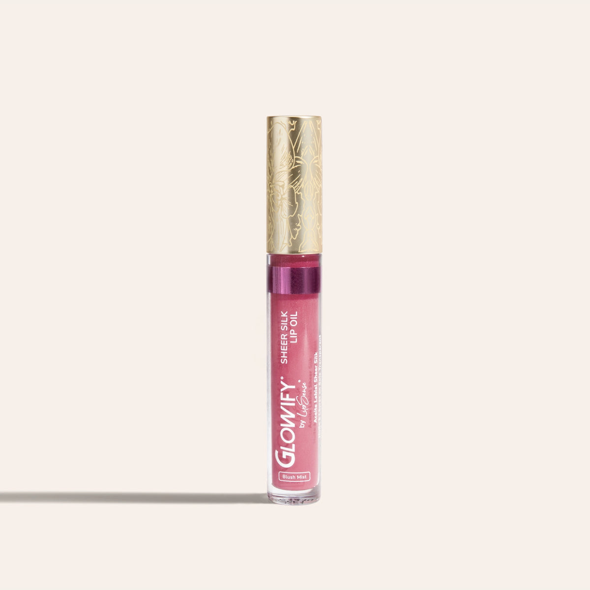 Glowify Sheer Silk Lip Oil by SeneGence: A clear tube of pink lip oil with an orchid-engraved gold cap.