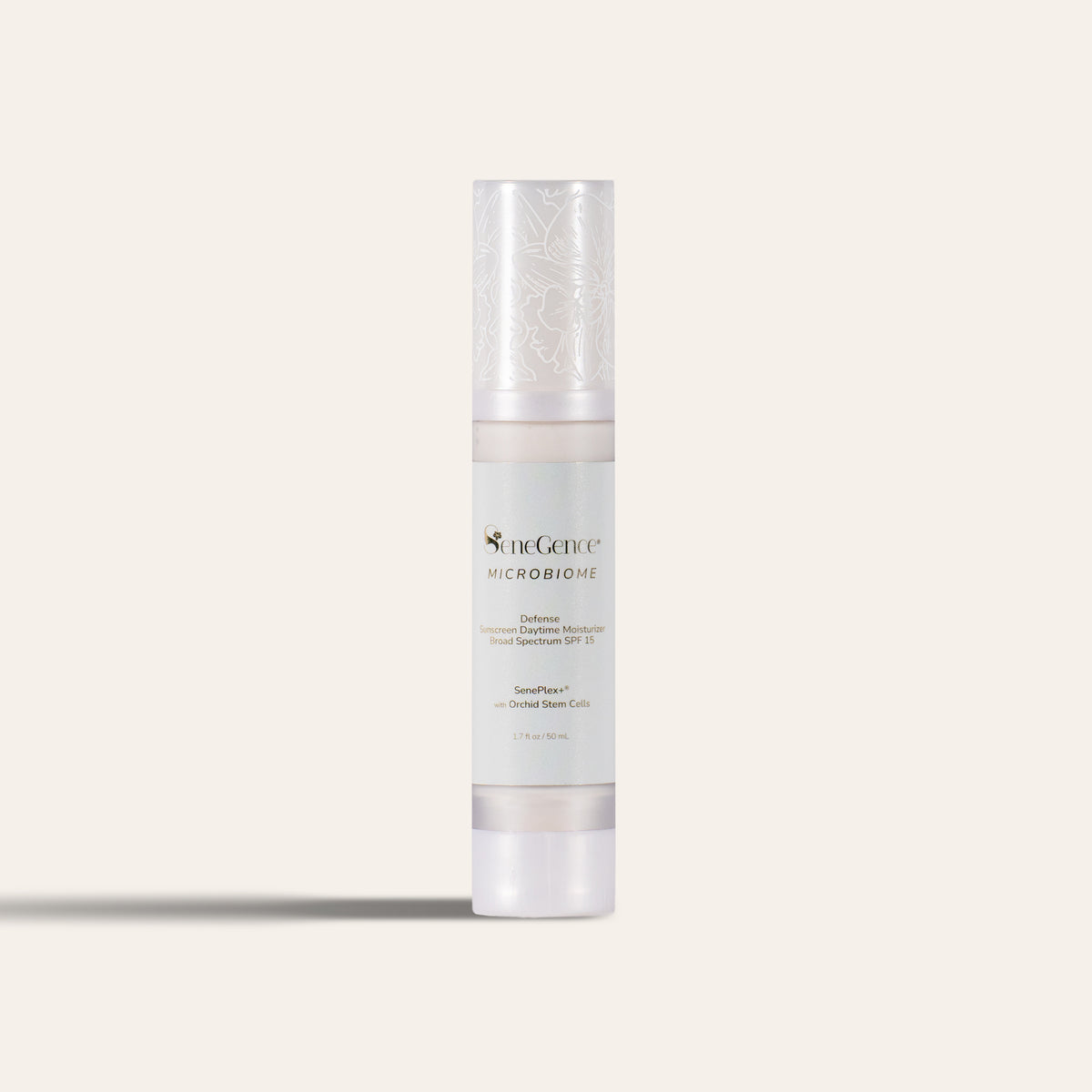 Microbiome Defense Daytime Moisturizer SPF 15 by SeneGence: A slim airless bottle with a frosted pearl-white cap printed with white orchid line art, a pale mint-grey label with gold-tone text and a frosted white base.