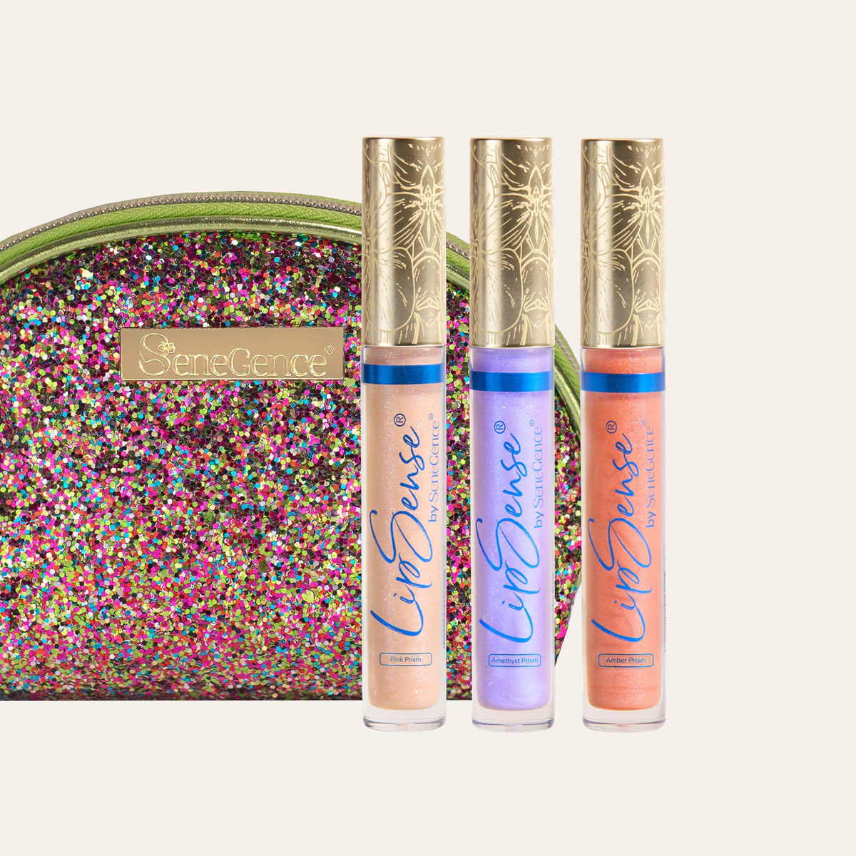 Prismatic LipSense Gloss Collection by SeneGence: Three gold-capped gloss tubes beside a multicolored sparkling pouch.